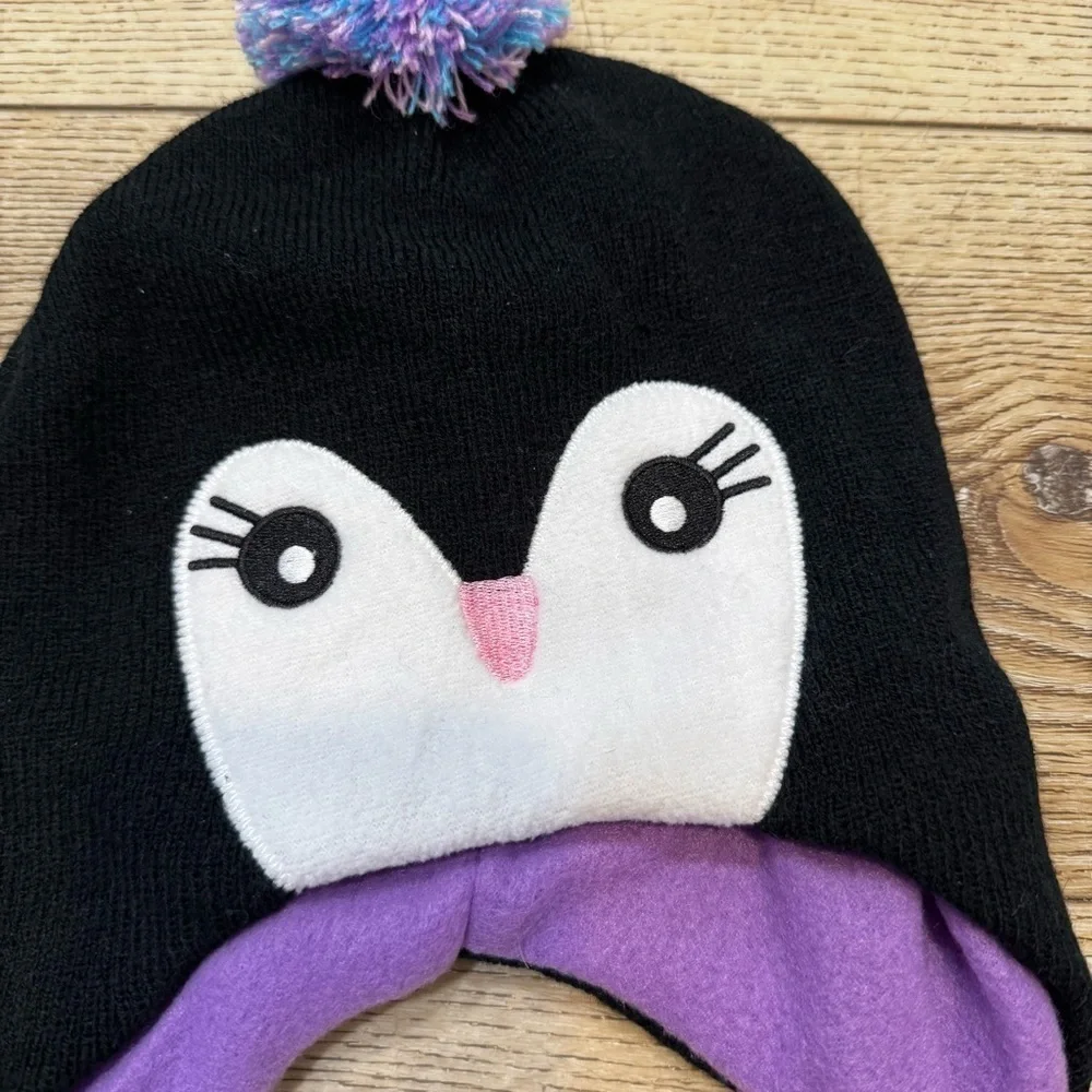 Penguin snow hat, black with white & purple, tassles, purple lining, stretchy.